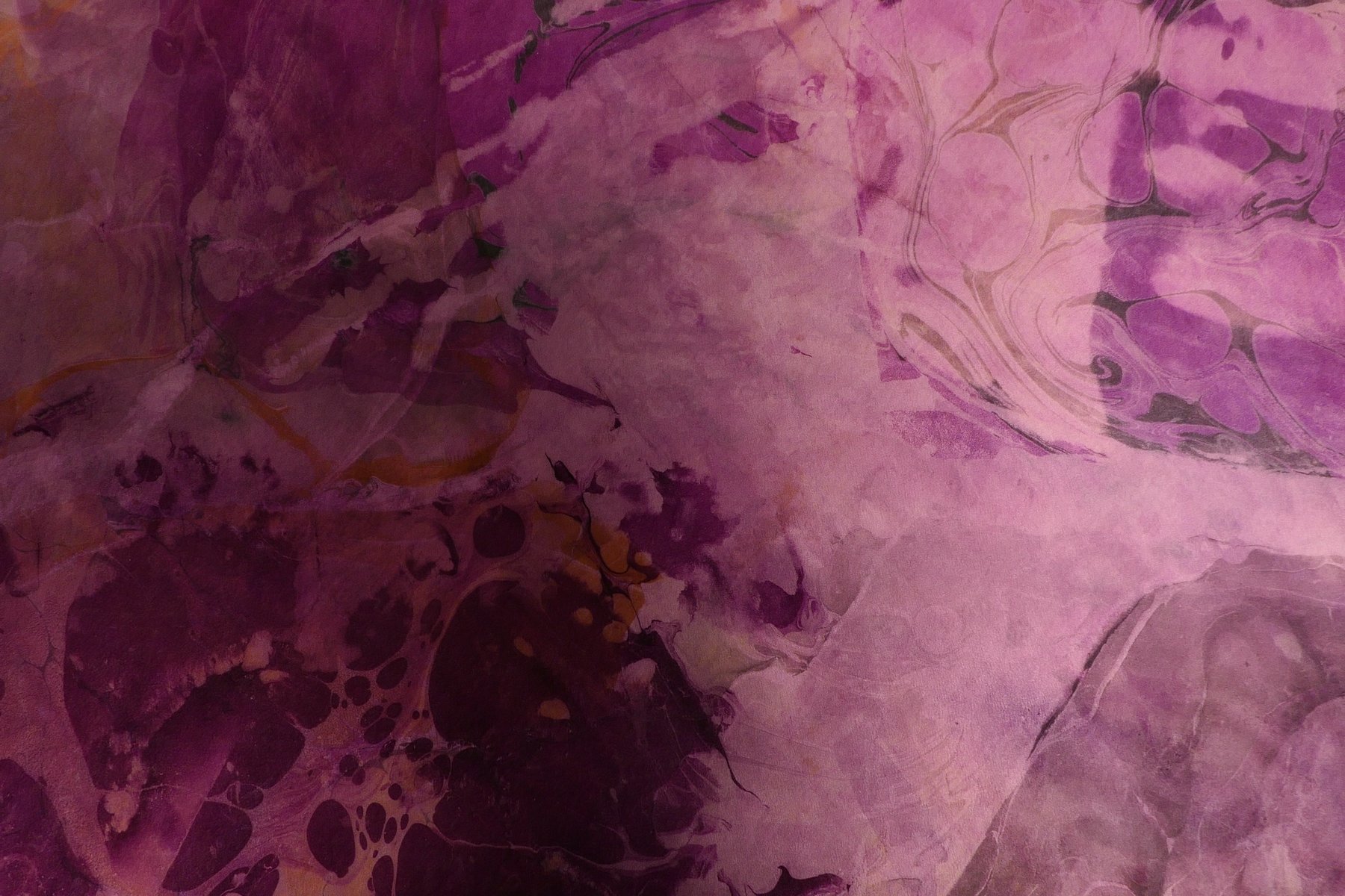 Close-up detail of marbled silk in deep plum and magenta tones