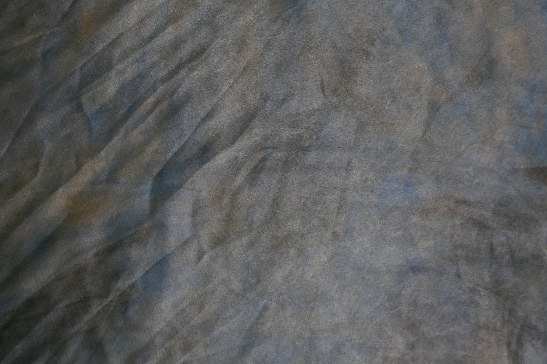 Close-up detail of marbled silk in muted slate blue and grey tones